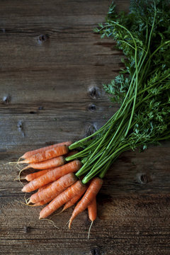Bunch of carrots on a wooden table