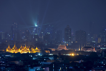 Grand palace with Bangkok skyscrapers at night in Bangkok,Thailand