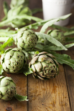 Globe artichokes on wooden table