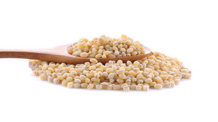 pearl barley in a wooden spoon isolated on white background