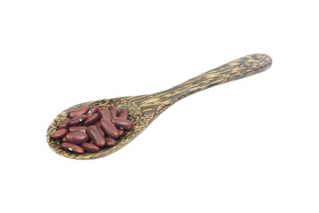 Red kidney beans on a wooden spoon isolate on white