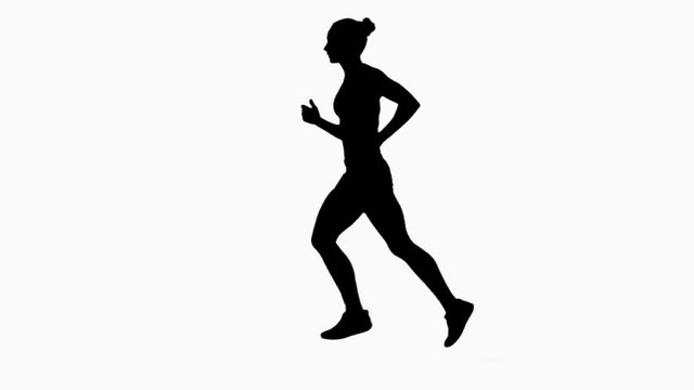 Woman jogging. Side view. Silhouette. Slow motion