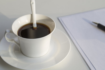 Business concept , blank paper and cup of fresh coffee on the table in office 