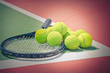 Tennis Ball with Racket on the clay tennis court