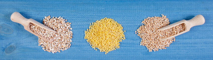 Heap of various groats on wooden boards, healthy food and nutrition