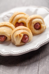 Pigs 'n blanket sausages and croissant rolls angled view