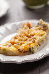 Egg omelet on small white plate with green smoothie in background