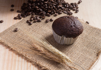Cupcake on fabric  with coffee beans background.