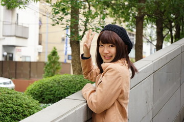 Young Japanese woman saying good-bye to her friend on the street