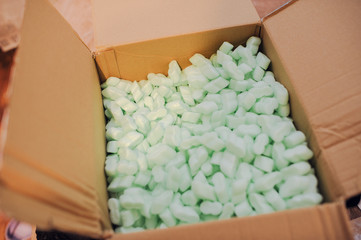 box filled with many white styrofoam pellets