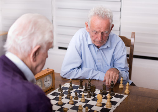 Senior men playing chess
