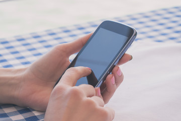 Using cellphone outdoors. Shallow depth of field.