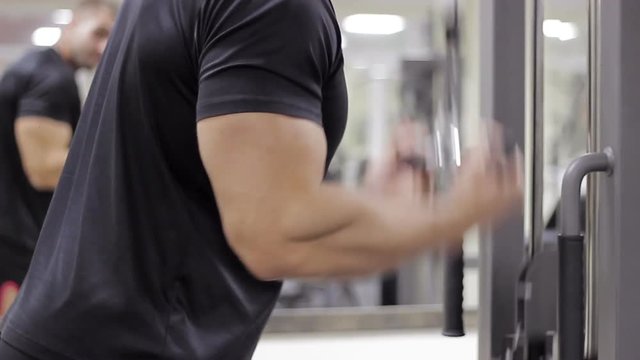 man has been in the gym training for bodybuilding pumping muscles