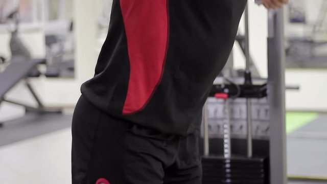 man has been in the gym training for bodybuilding pumping muscles
