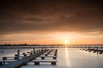 Obraz premium Yacht port over orange sunset