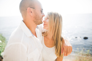 Fototapeta premium Happy romantic fashion couple in love have fun on beautiful sea at summer day