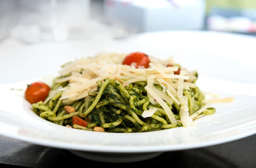 Pasta with pesto sauce and nuts on a the table