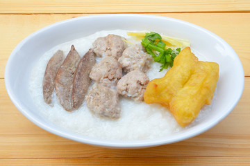 Congee with pork and ginger slices on top Rice porridge with pork 
