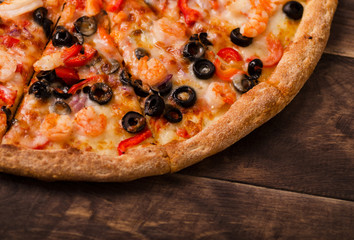 Pizza with seafood view from above on a wooden table