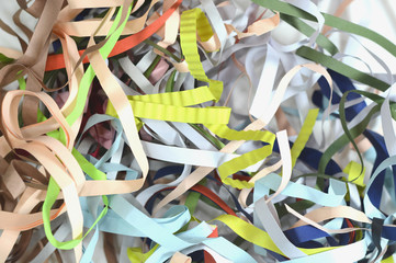 Colorful strip of papers that are tangled together.
