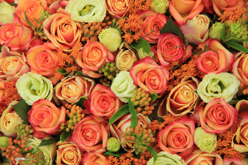 Orange and yellow roses in a bridal bouquet