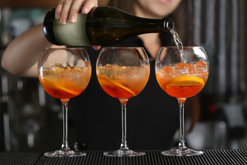 Woman hands making cocktail on bar counter
