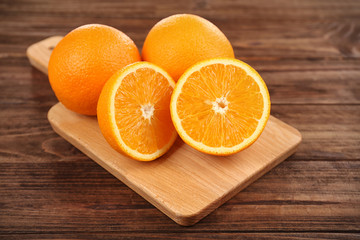 Fresh oranges on cutting board