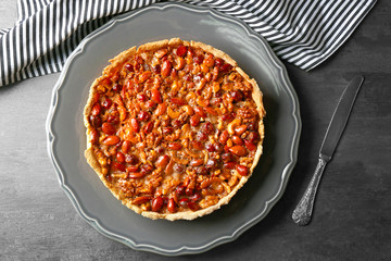 Delicious cake with nuts on table