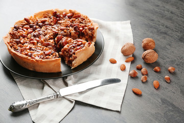 Delicious cake with nuts on table