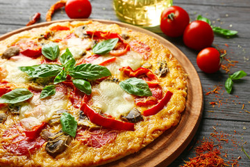 Tasty pizza on wooden table