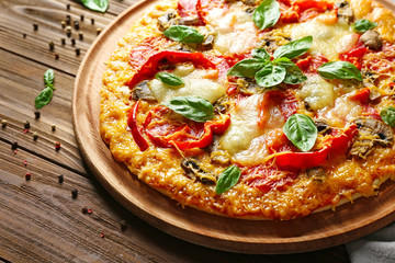 Tasty pizza on wooden table