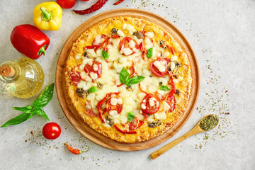 Tasty pizza with ingredients on table