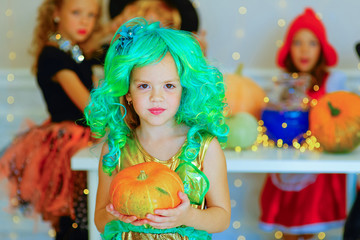 Happy group of children in costumes during Halloween party