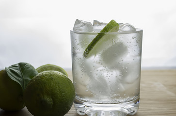 Gin and tonic cocktail with lime and ice