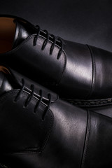 Black oxford shoes on  background. Back view. Close up.