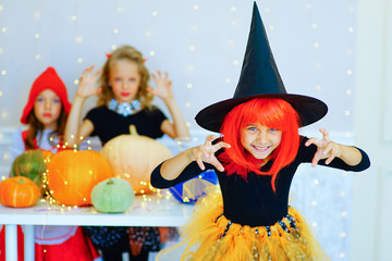 Happy group of children in costumes during Halloween party