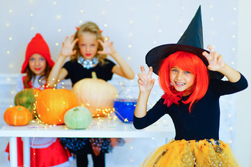 Happy group of children in costumes during Halloween party