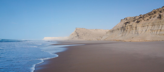 sand cliffs of Dakhla in Western Sahara region of Morocco, with sea - obrazy, fototapety, plakaty
