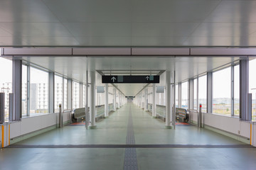 walkway with long horizontal escalator at international airport