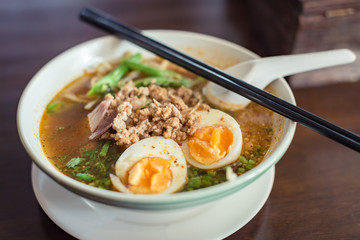 Noodle Tom Yam, hot spicy soup served with boiled egg.