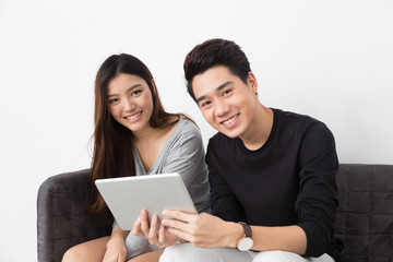 Asian couple playing tablet
