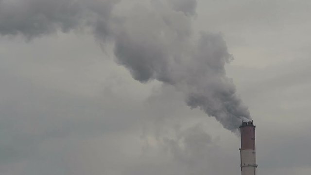 Smoking pipe of thermal power plant on cloudy background