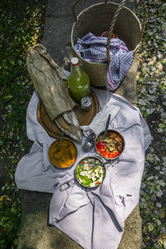 Picnic Basket And Blanket With Artisan Bread And Vegan Dishes. T