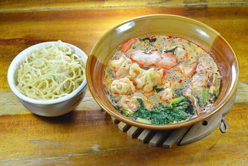 egg noodle and Chinese pork dumpling in spicy soup