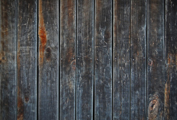 Fototapeta premium Dark old wooden fence. wood palisade background. planks texture. Black