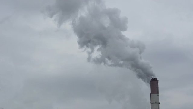 Smoking pipes of thermal power plant on cloudy background