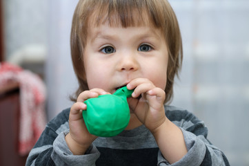 Little girl intend to blow up ball