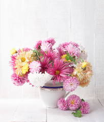 Bouquet of colorful chrysanthemums  on old white wooden board.