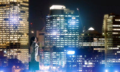 Woman looking at night city