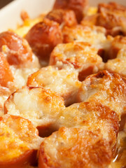 Casserole with sausage and mozzarella in a baking dish, close up
